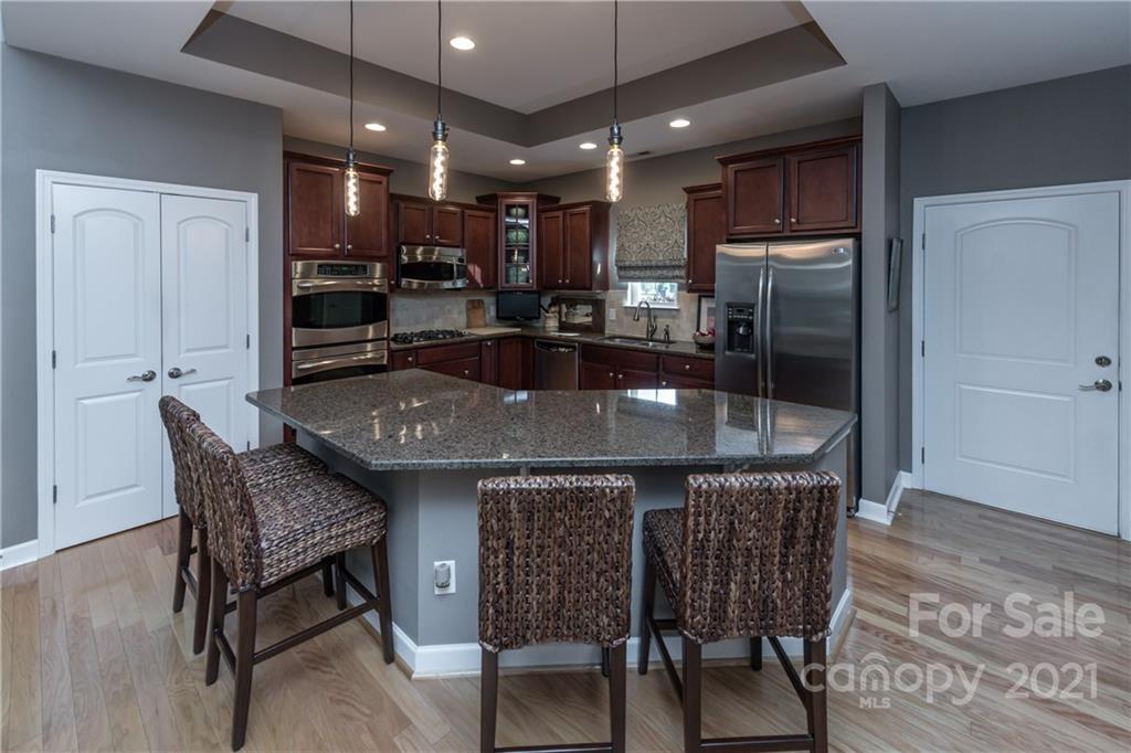 4825 Polo Gate Boulevard Charlotte, NC 28216 - Photo 27 of 30 a kitchen with a table and chairs in it