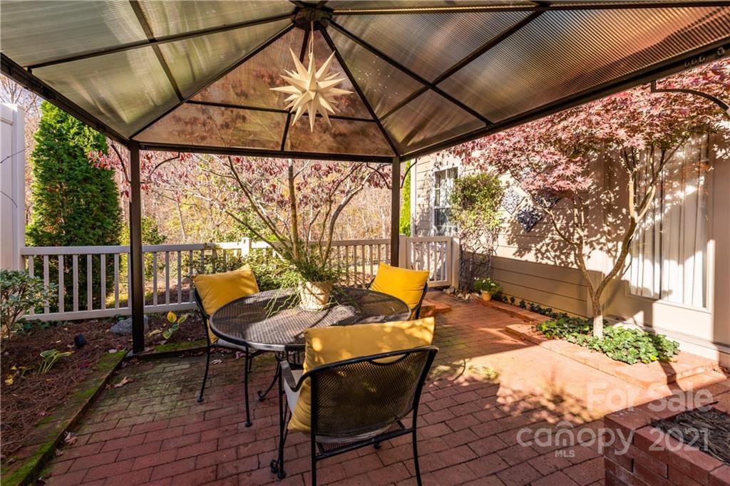 4825 Polo Gate Boulevard Charlotte, NC 28216 - Photo 30 of 30 a patio with glass top table and chairs