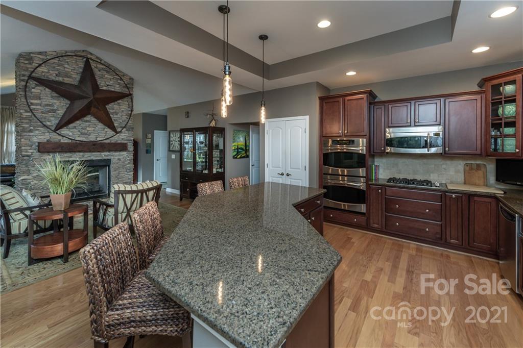 4825 Polo Gate Boulevard Charlotte, NC 28216 - Photo 6 of 30 a kitchen with stainless steel appliances granite countertop a stove oven and a refrigerator