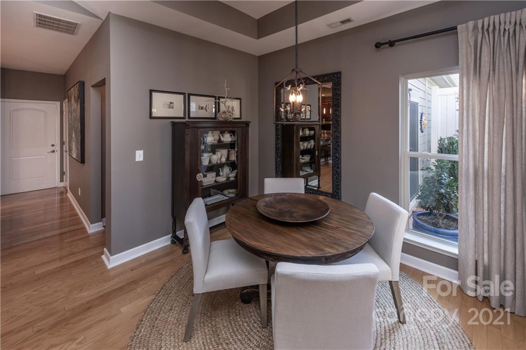 4825 Polo Gate Boulevard Charlotte, NC 28216 - Photo 8 of 30 a view of a dining room with furniture and wooden floor