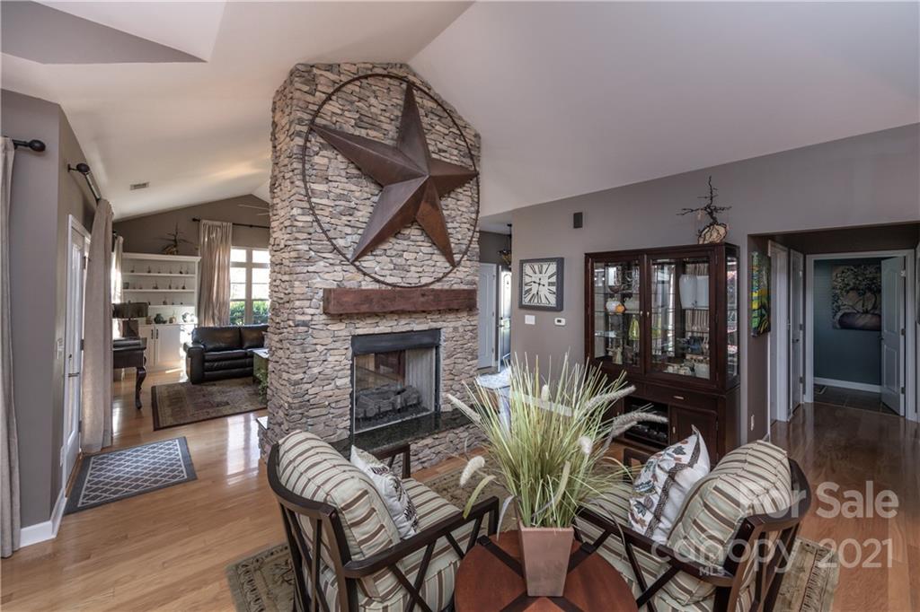 4825 Polo Gate Boulevard Charlotte, NC 28216 - Photo 10 of 30 a living room with furniture a fireplace and a potted plant