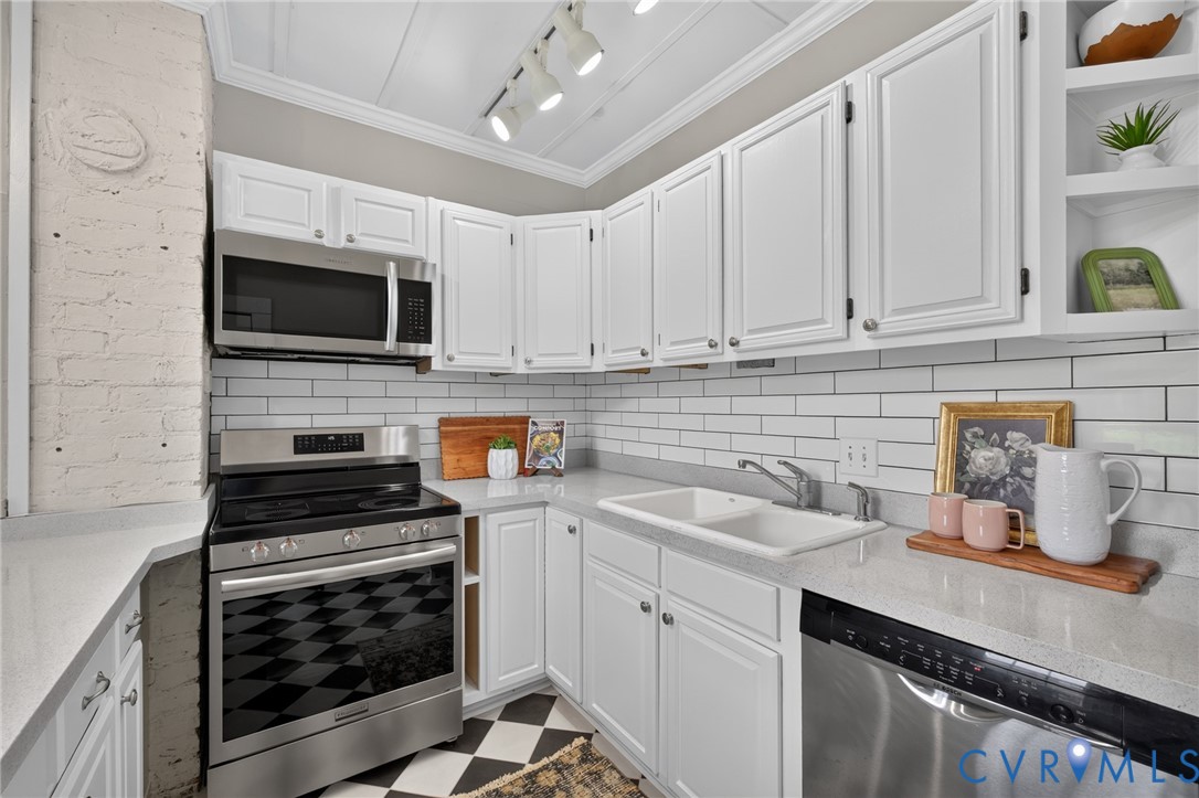 210 Henry Clay Road Ashland, VA 23005 - Photo 14 of 59 Galley kitchen featuring white cabinetry, stone co