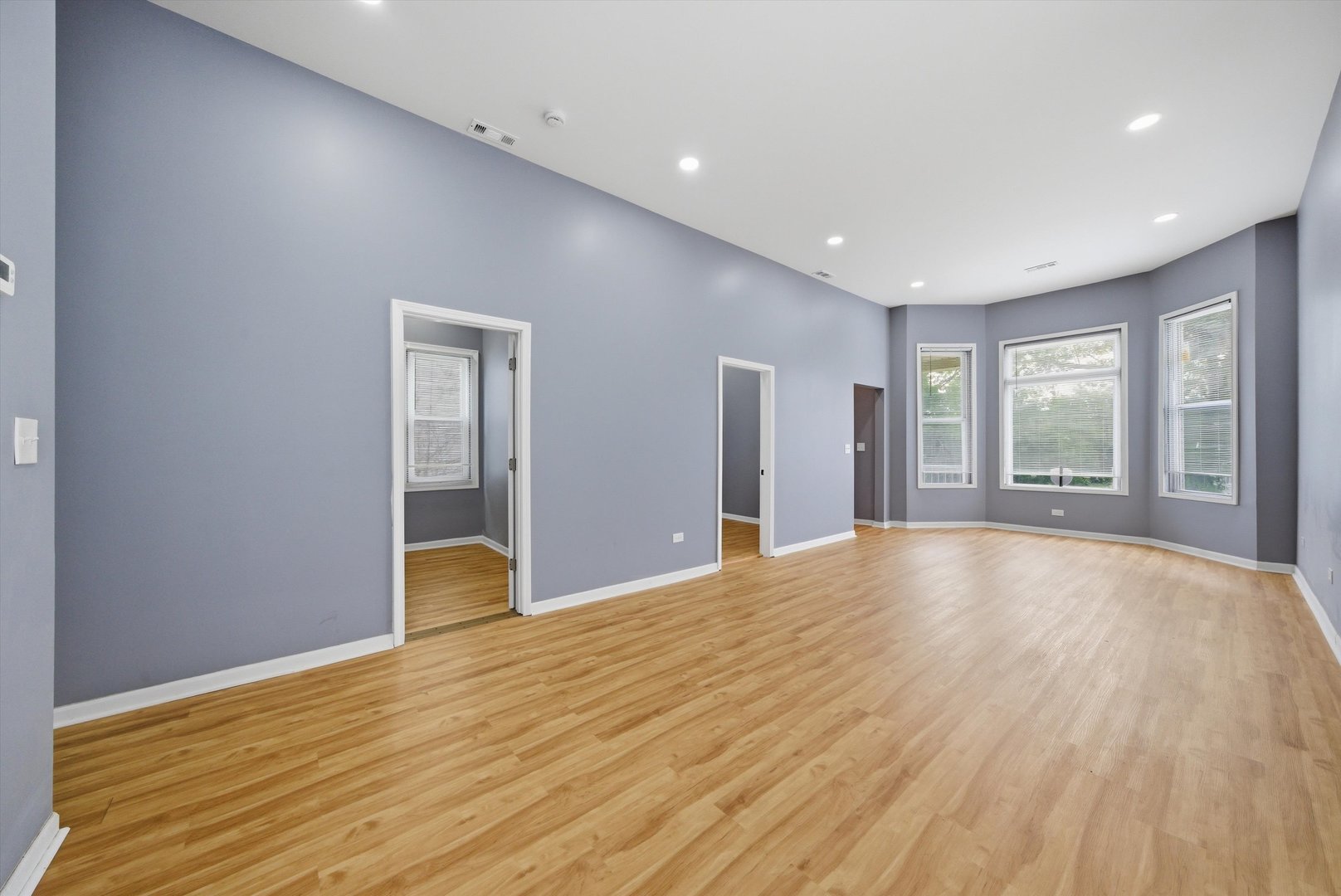 7828 South Escanaba Avenue Chicago, IL 60649 - Photo 8 of 41 a view of an empty room with wooden floor and a window