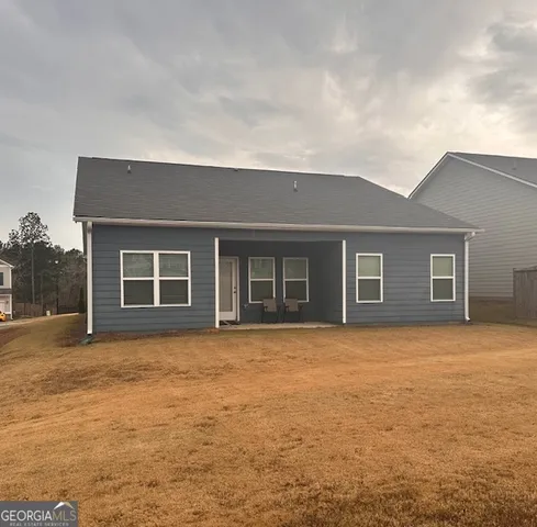 a backyard of a house with large trees