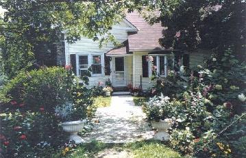 416 Main Road Monterey, MA 01245 - Photo 1 of 1 a front view of a house with a yard garage and outdoor seating