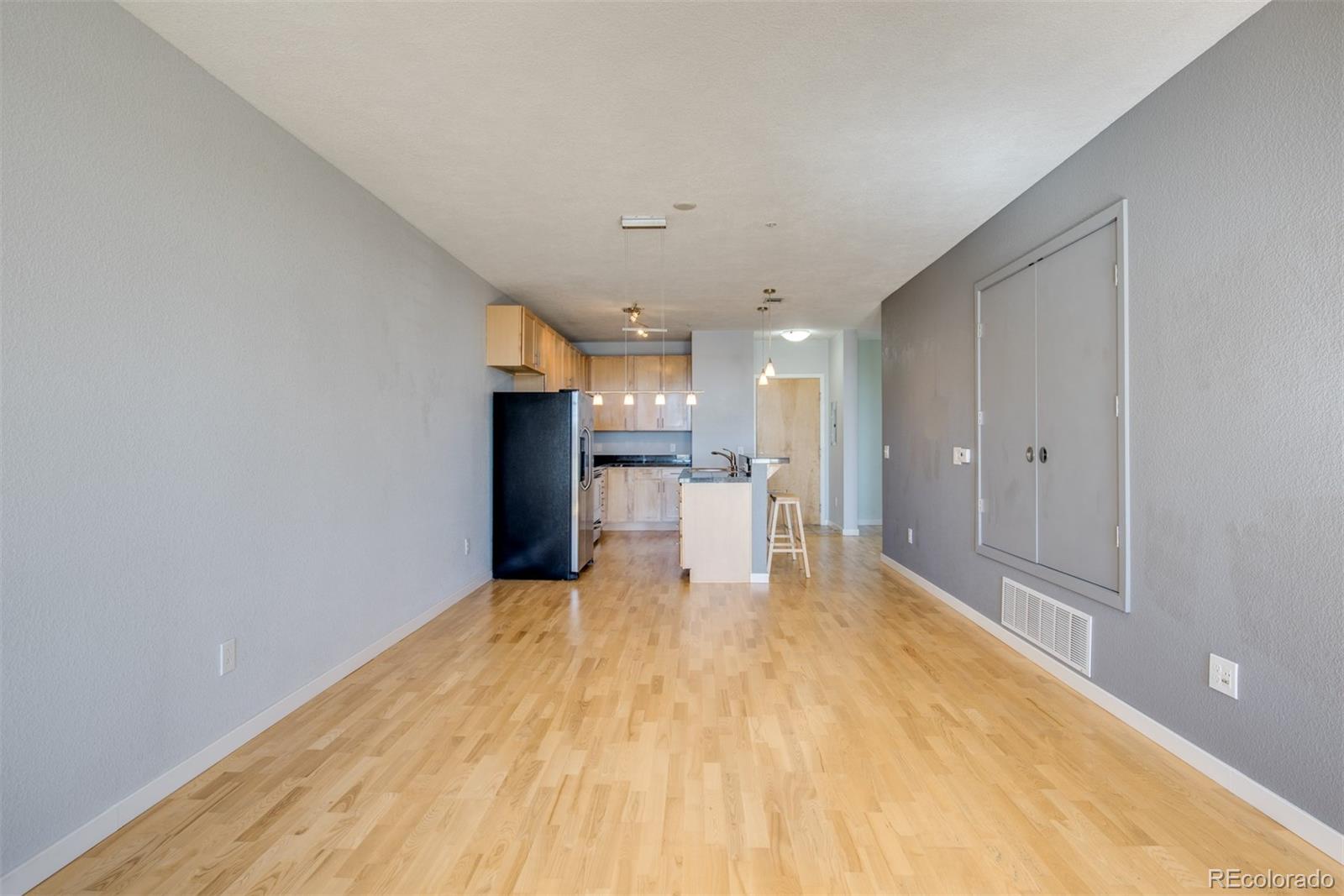 3101 Blake Street, Unit 308 Denver, CO 80205 - Photo 8 of 30 a big room with wooden floor and a large window