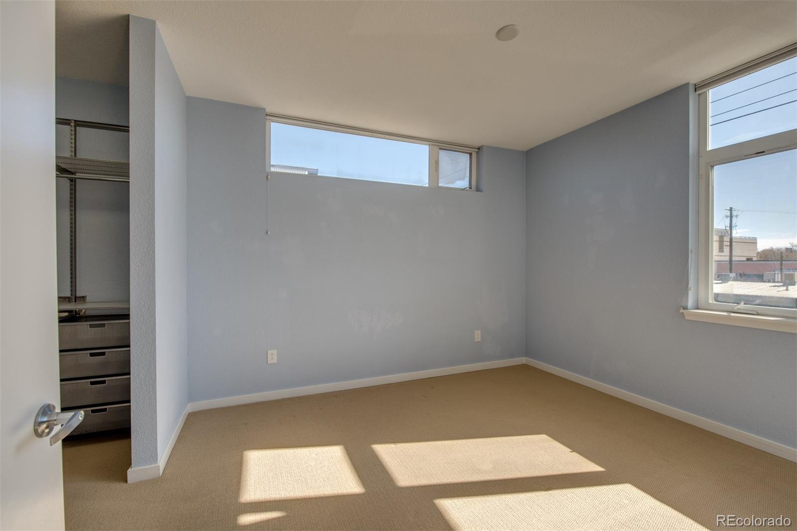 3101 Blake Street, Unit 308 Denver, CO 80205 - Photo 10 of 30 a view of an empty room with a window