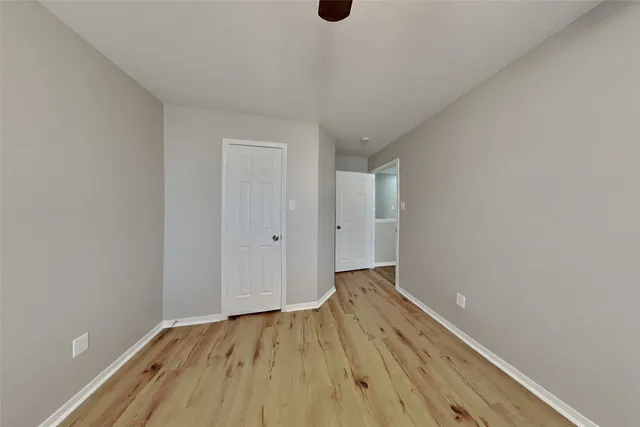 a view of an empty room and wooden floor
