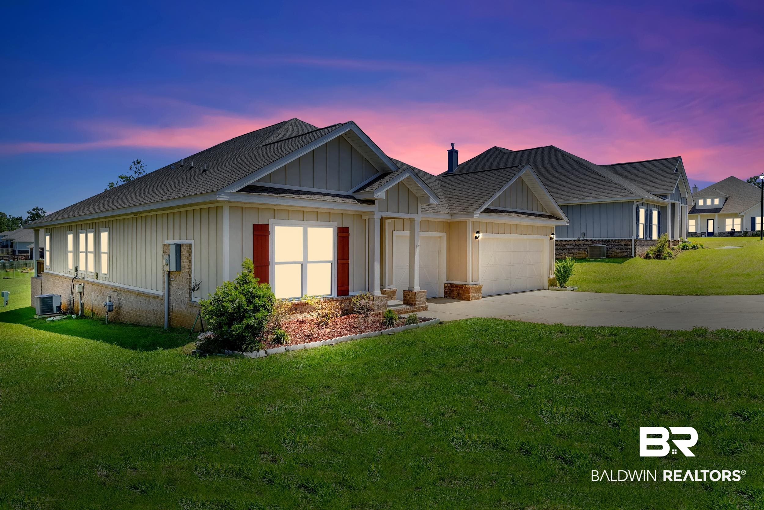 27862 Jade Court Daphne, AL 36526 - Photo 2 of 33 View of front of house featuring cooling unit, driveway, a garage, board and batten siding, and a yard