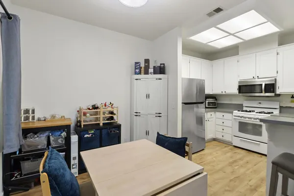 a kitchen with stainless steel appliances a stove refrigerator and a refrigerator