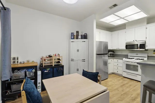 a kitchen with stainless steel appliances a stove refrigerator and a refrigerator