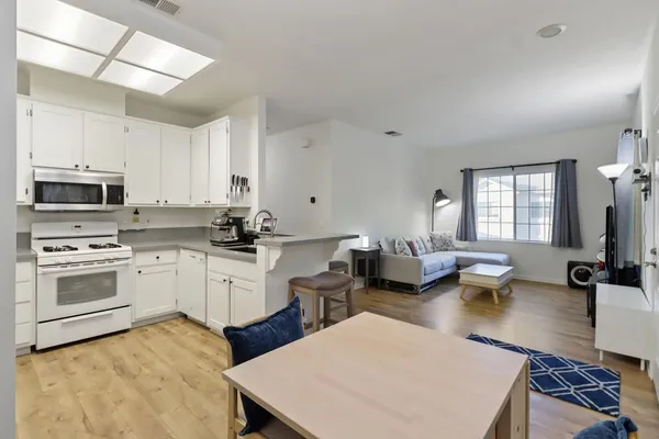 a kitchen with a stove a sink and a refrigerator