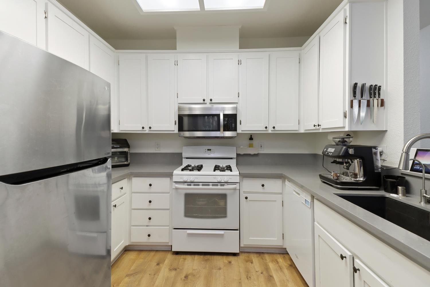 1175 Greene Terrace Davis, CA 95618 - Photo 18 of 35 a kitchen with appliances a sink and cabinets