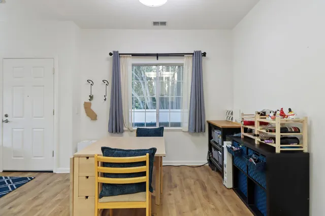 a living room with a bed furniture and a window