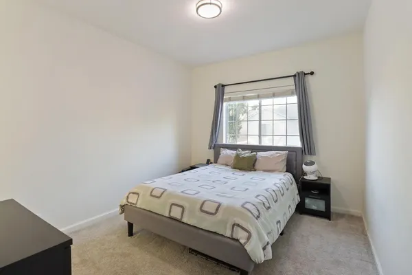 a bedroom with a bed and window