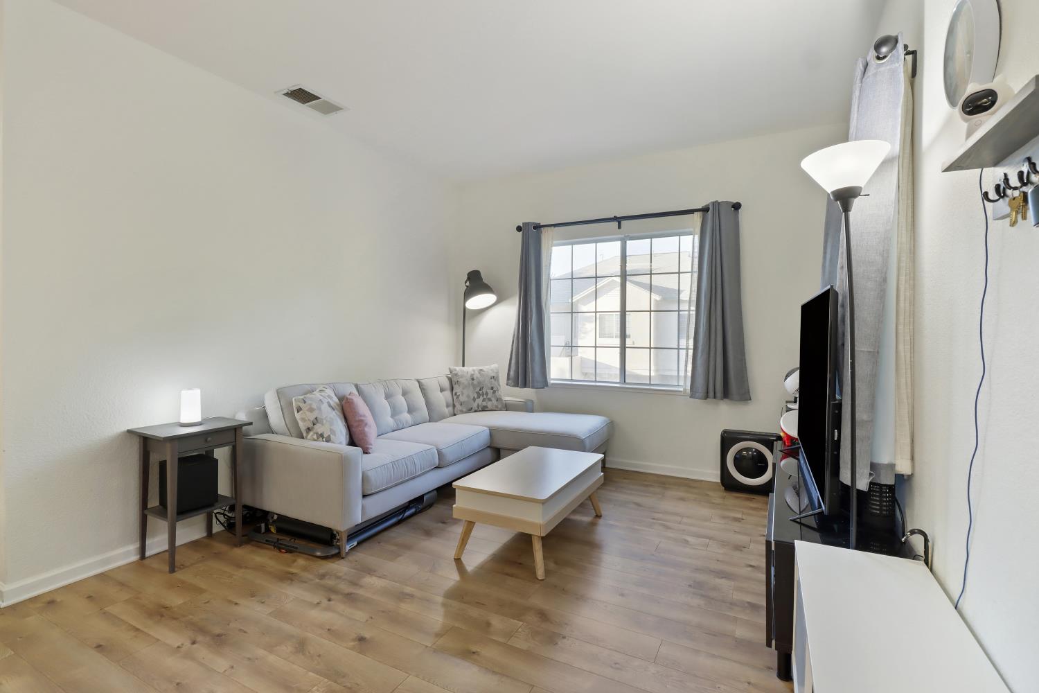 1175 Greene Terrace Davis, CA 95618 - Photo 9 of 35 a living room with furniture a window and a flat screen tv