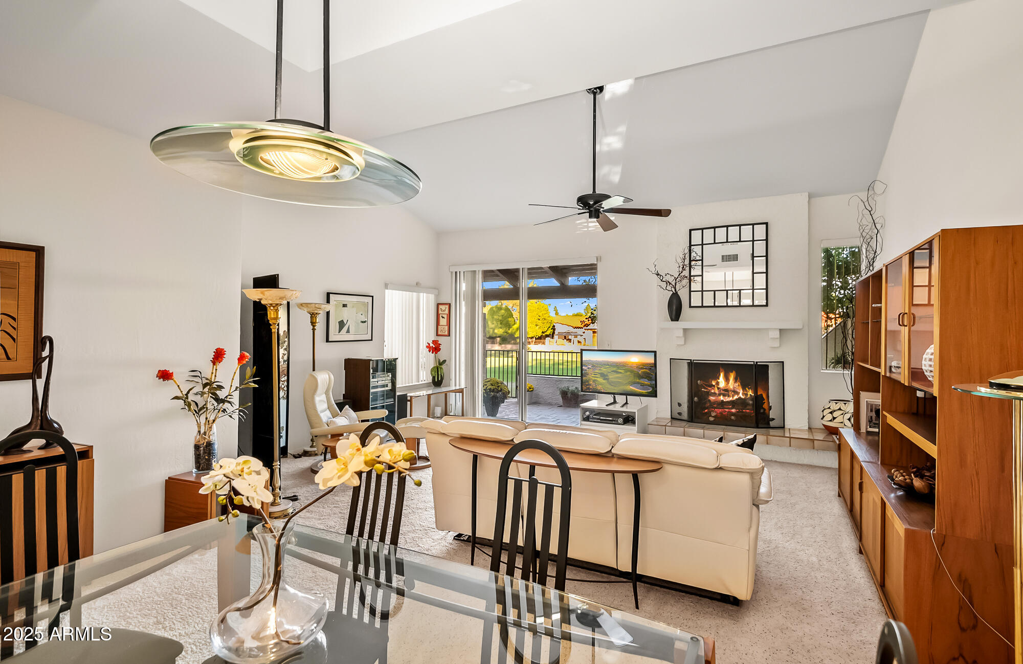 a view of a dining room with furniture a fireplace and chandelier
