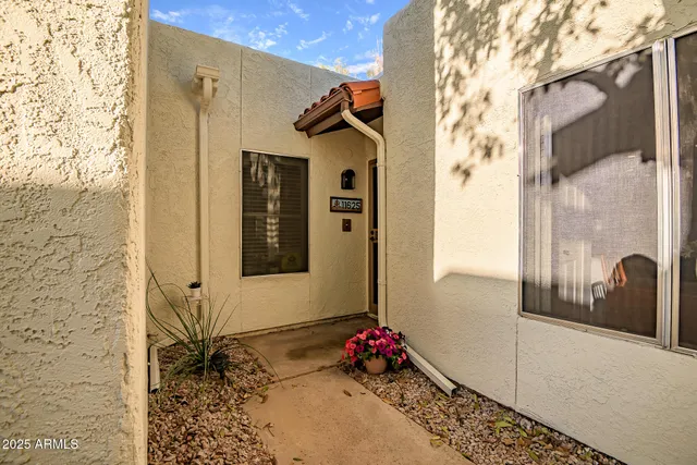 a view of a balcony with floor to ceiling windows and wooden fence