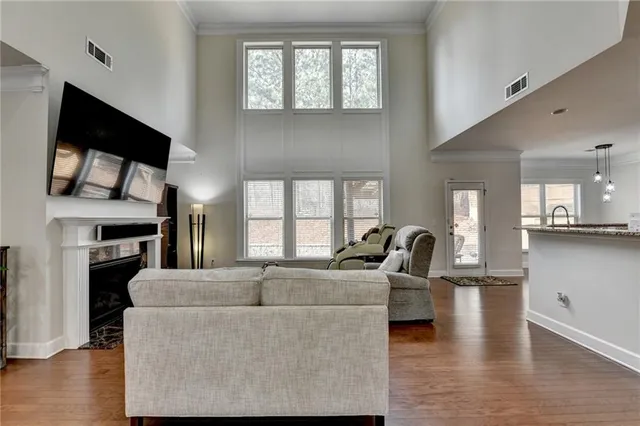 a kitchen with granite countertop a sink a stove and cabinets