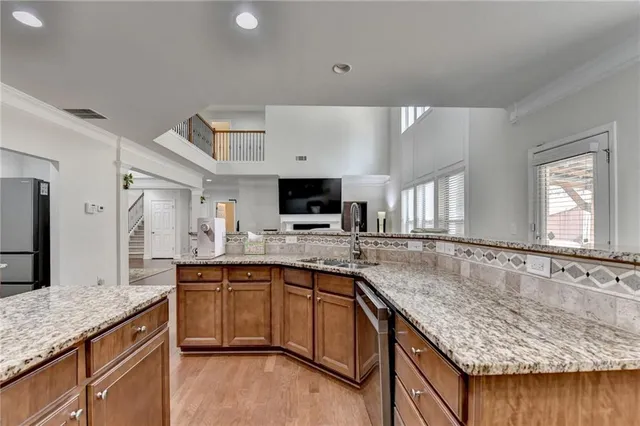 a bedroom with a bed a dresser and a chandelier