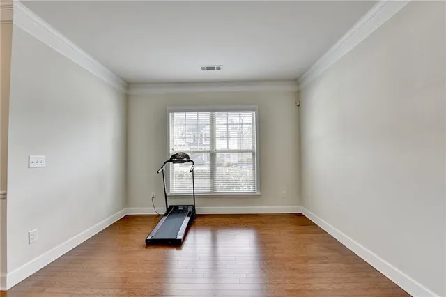 a living room with furniture wooden floor and kitchen view