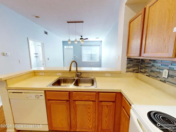 a kitchen with a sink and a refrigerator