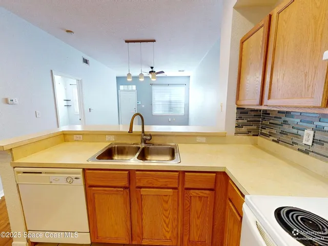 a kitchen with a sink and a refrigerator