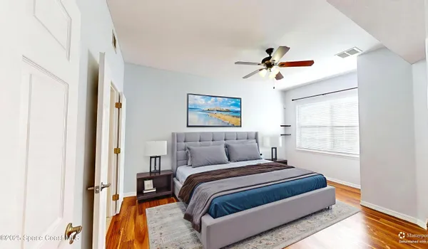 a bedroom with a bed and a chandelier