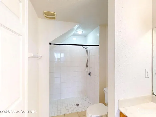 a bathroom with a shower and toilet
