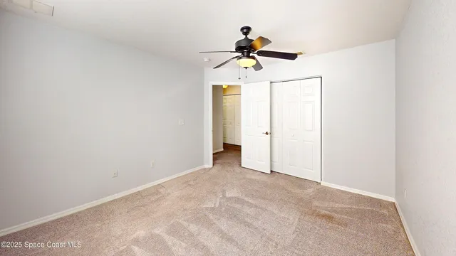 a view of room with a ceiling fan and window