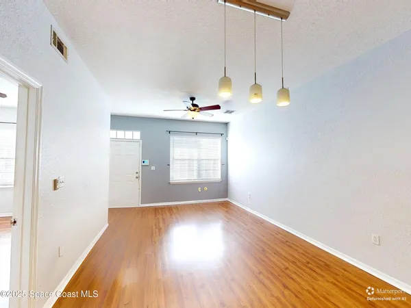 a view of a room with wooden floor