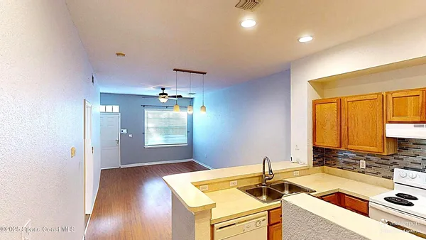 a room with gym equipment and wooden floor