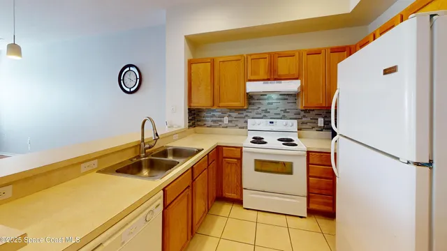 a kitchen with a stove and a refrigerator