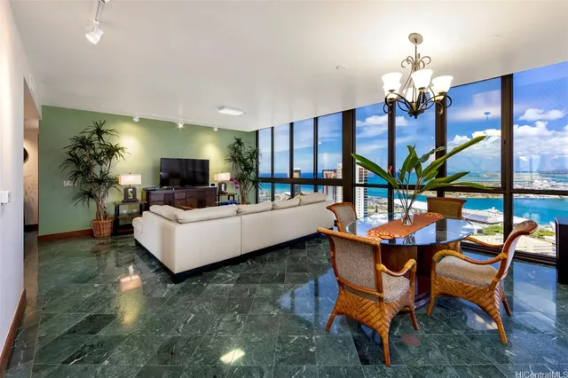 a living room with furniture and a chandelier