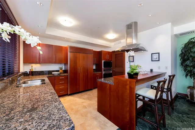a large kitchen with stainless steel appliances a large counter top
