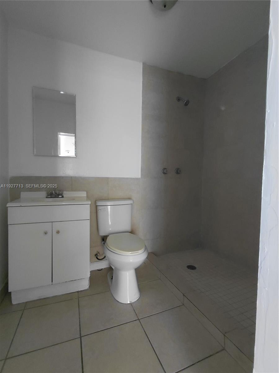 3171 Northwest 28th Street, Unit 1 Miami, FL 33142 - Photo 11 of 12 a bathroom with a sink toilet and shower