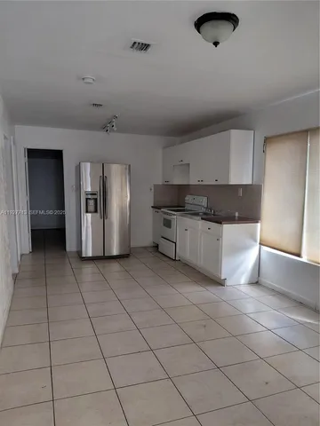 a view of a kitchen with cabinets and stainless steel appliances