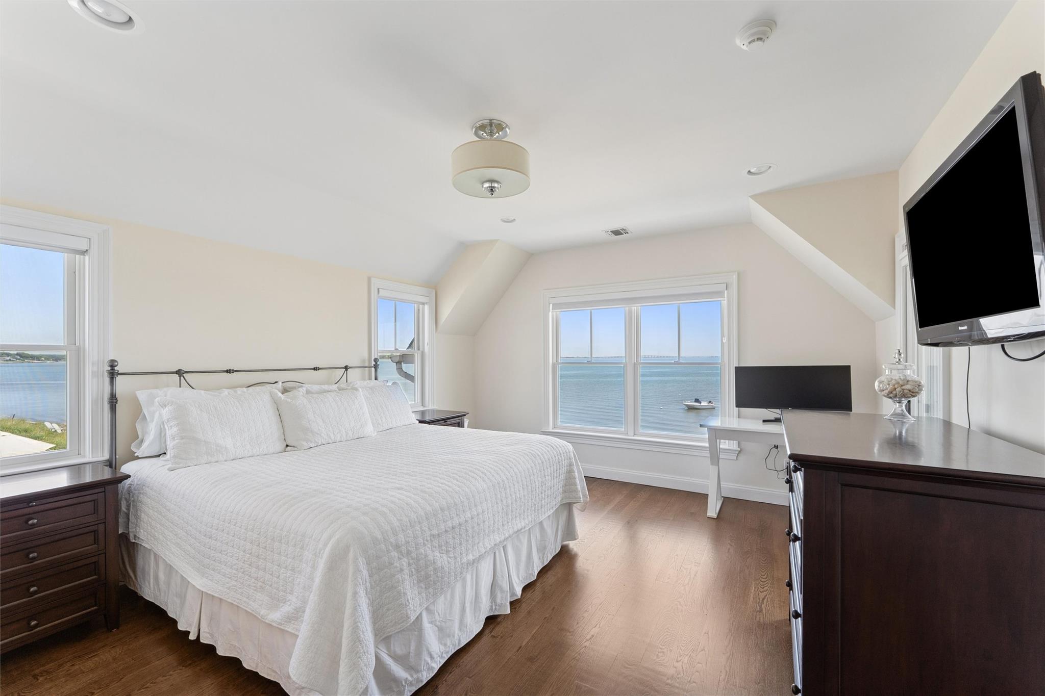 9 Shinnecock Road East Quogue, NY 11942 - Photo 18 of 34 a bedroom with a bed and a flat screen tv