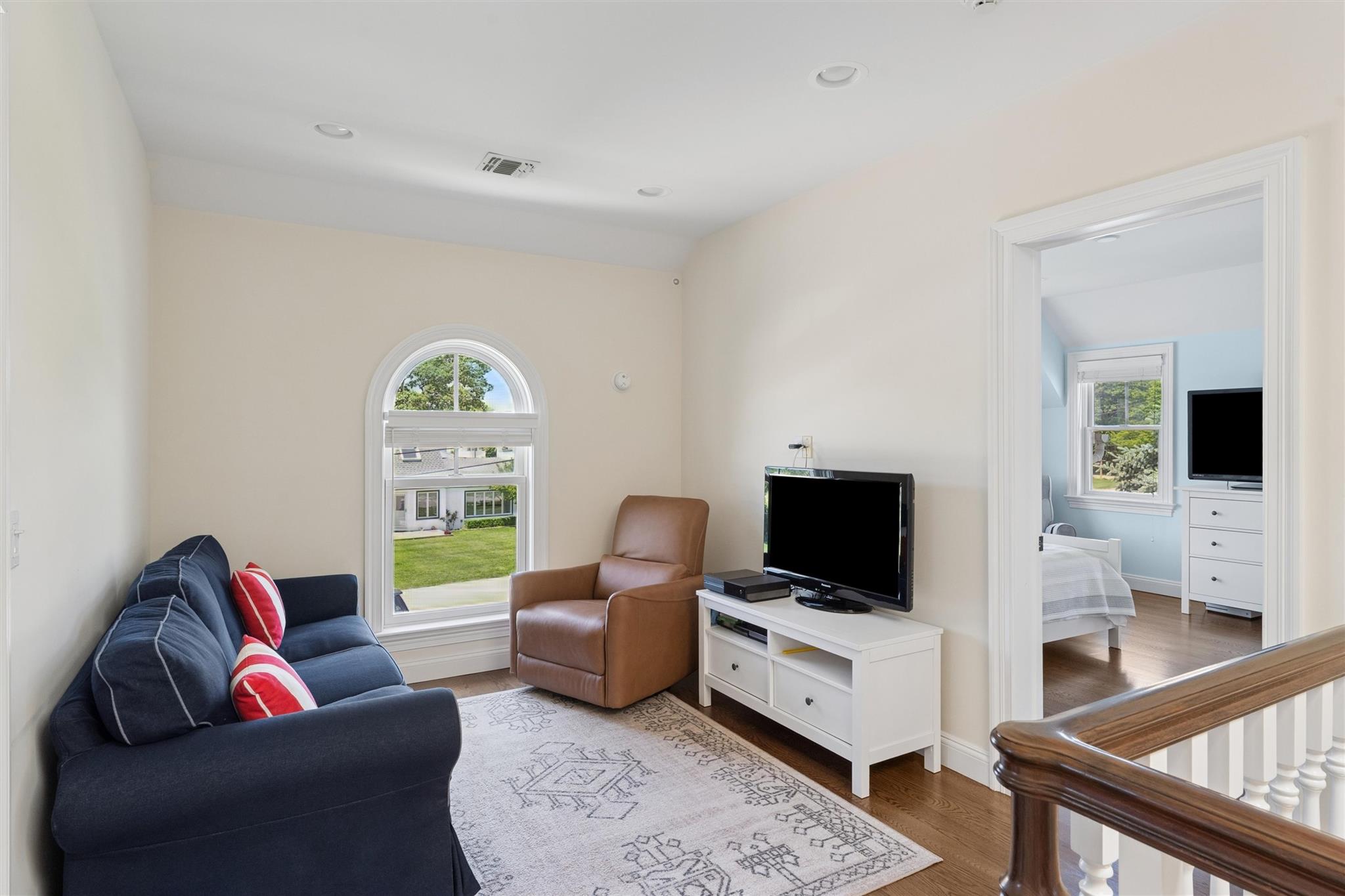 9 Shinnecock Road East Quogue, NY 11942 - Photo 20 of 34 a living room with furniture and a flat screen tv