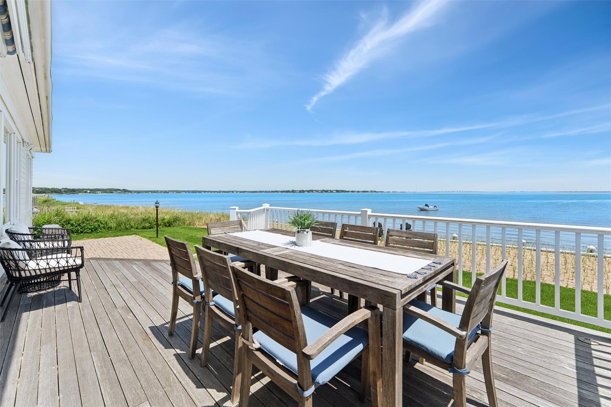 9 Shinnecock Road East Quogue, NY 11942 - Photo 22 of 34 a balcony with wooden floor and outdoor seating