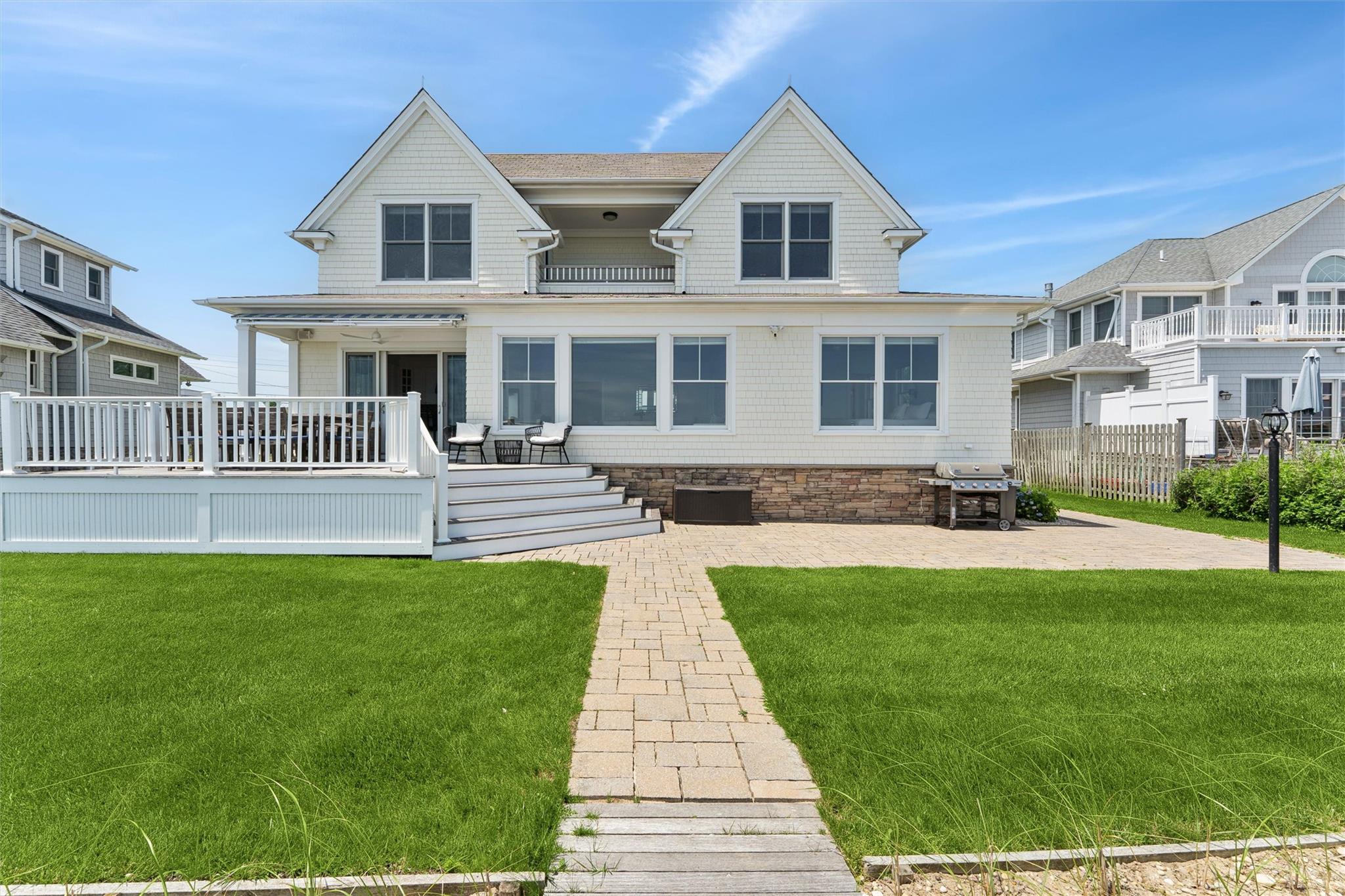 9 Shinnecock Road East Quogue, NY 11942 - Photo 24 of 34 a front view of a house with a yard