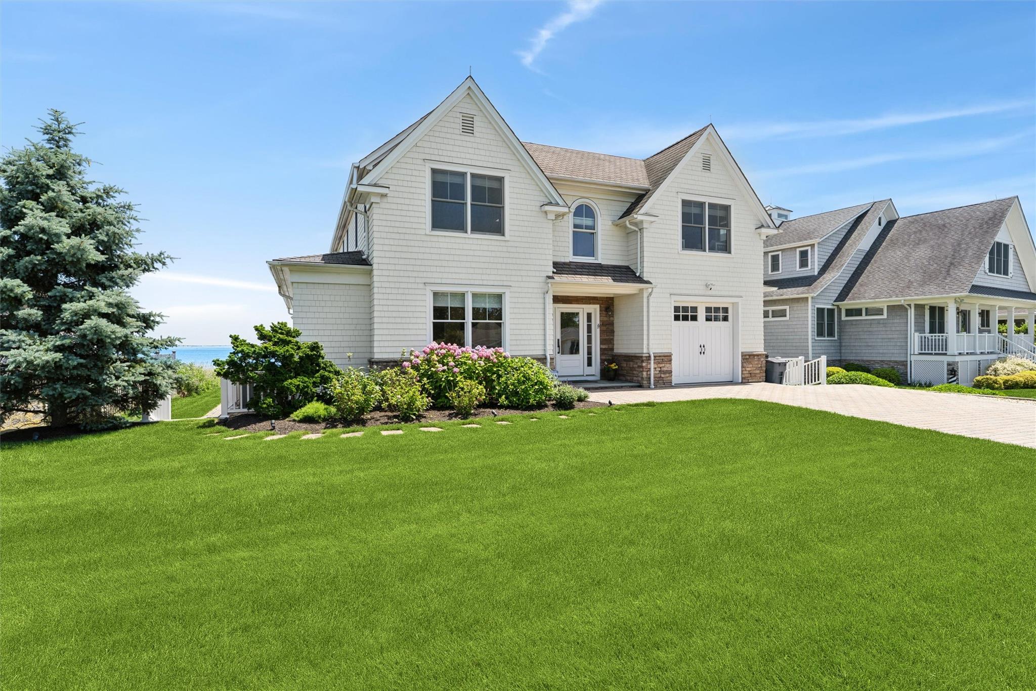 9 Shinnecock Road East Quogue, NY 11942 - Photo 29 of 34 a front view of a house with a yard