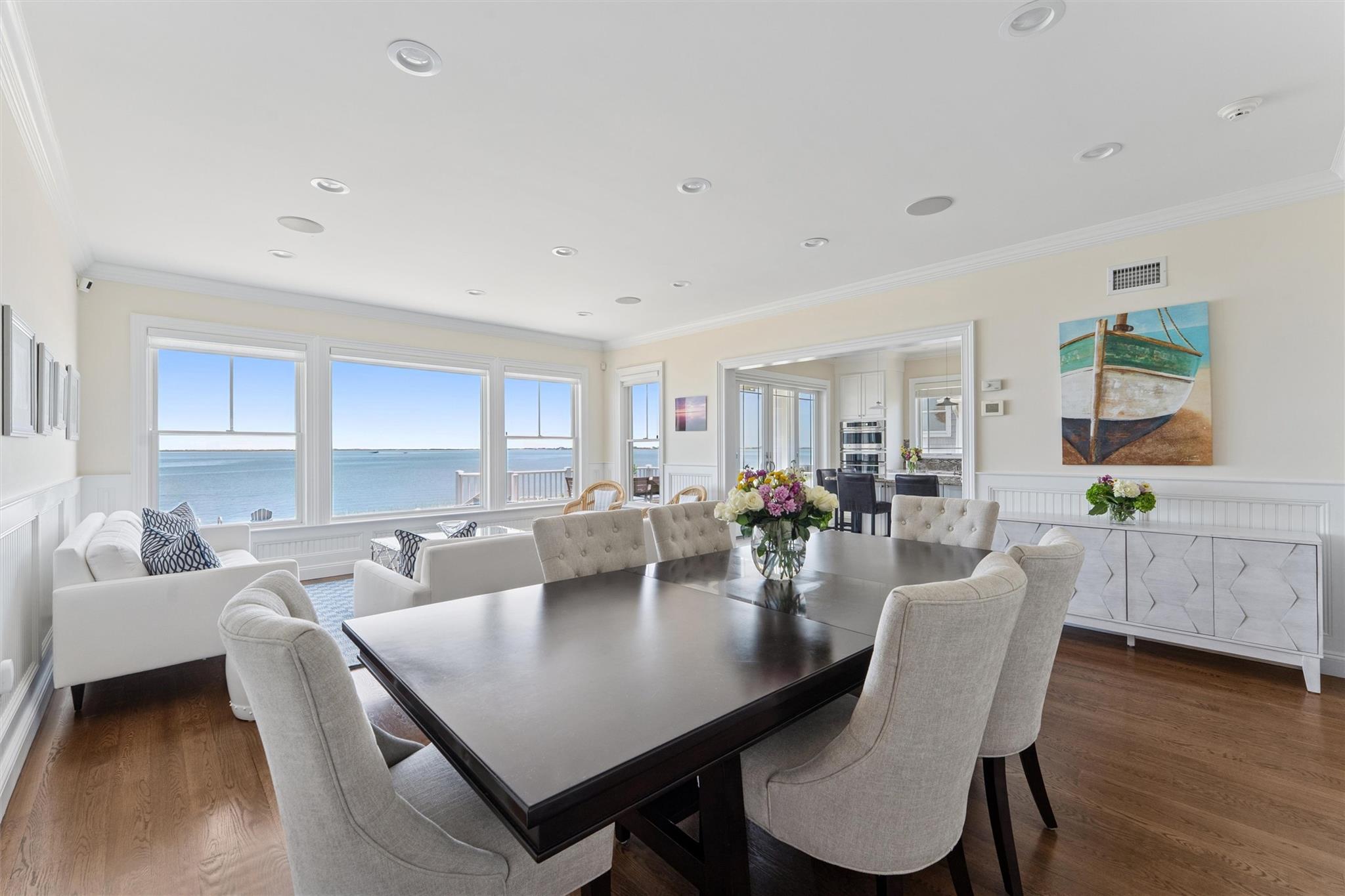 9 Shinnecock Road East Quogue, NY 11942 - Photo 6 of 34 a view of a dining room and livingroom with furniture wooden floor a rug and a chandelier