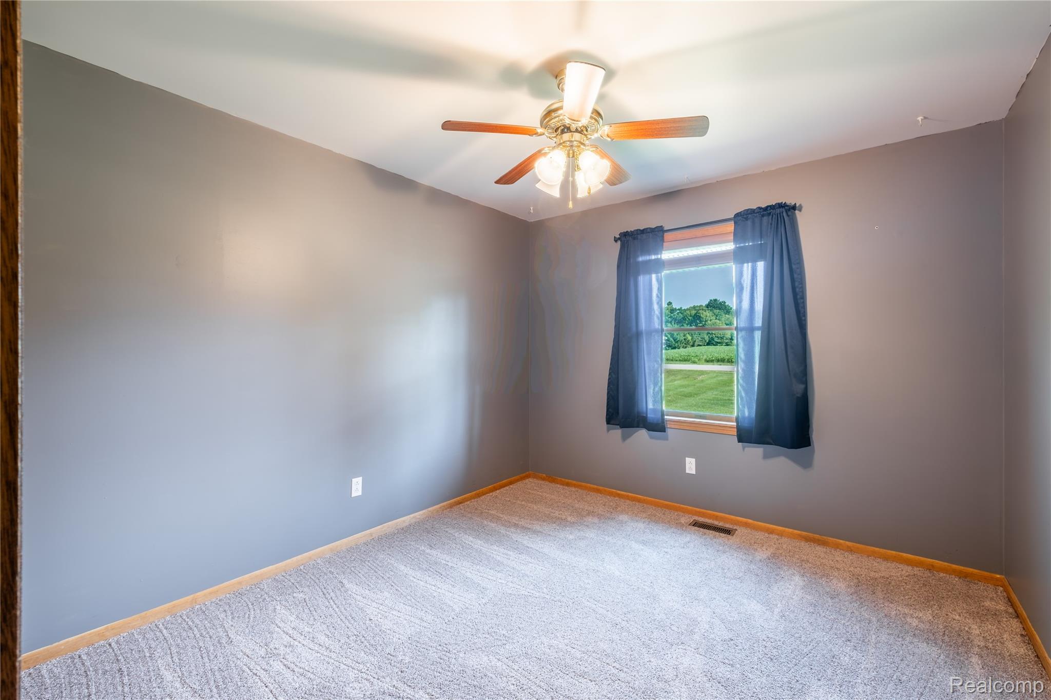 9600 Hamill Road Otisville, MI 48463 - Photo 17 of 32 Carpeted room featuring a single window and a ceiling fan with light fixture