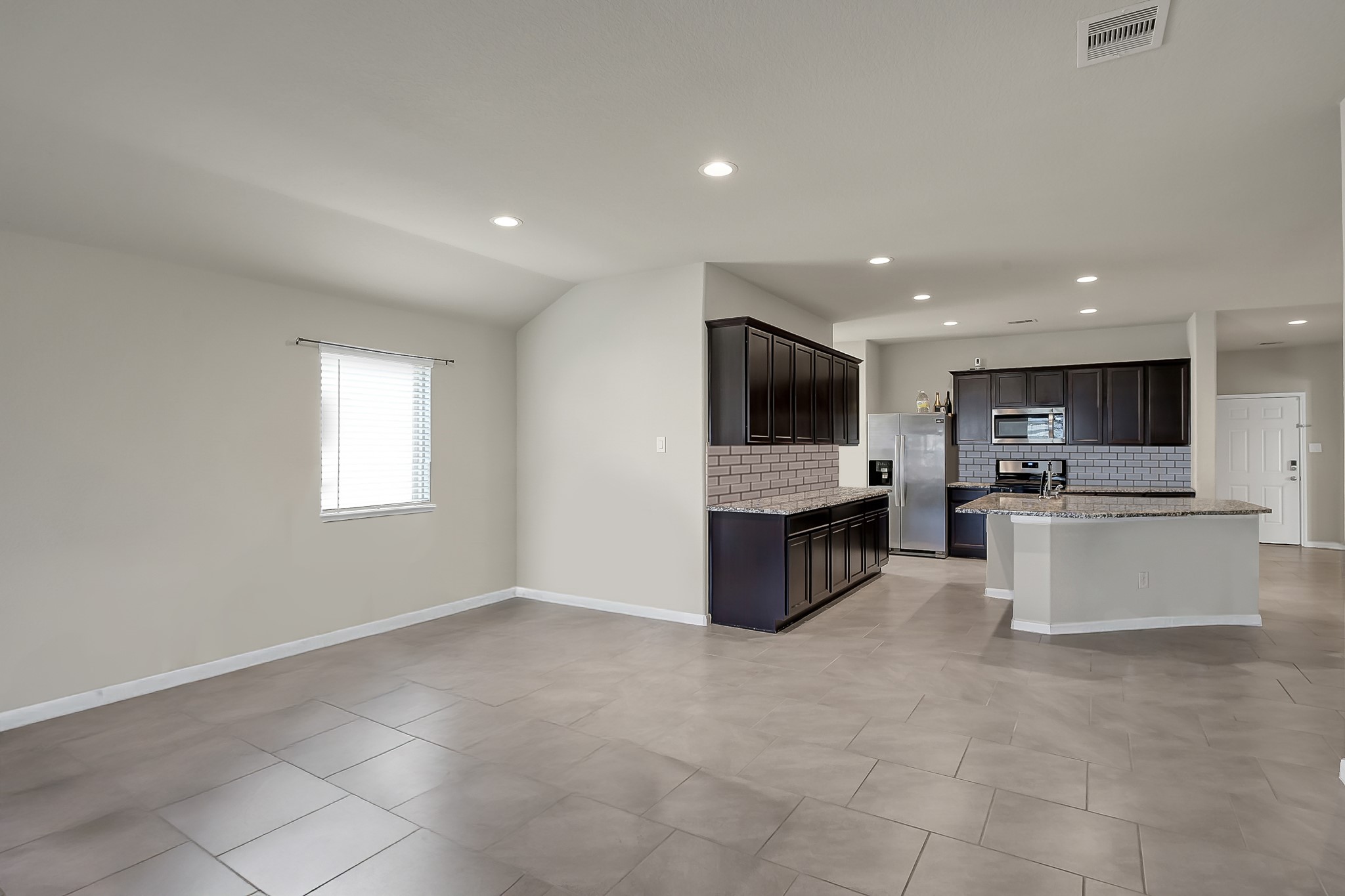 3310 Scout Island Katy, TX 77494 - Photo 11 of 42 a large kitchen with stainless steel appliances a large counter top and a stove top oven