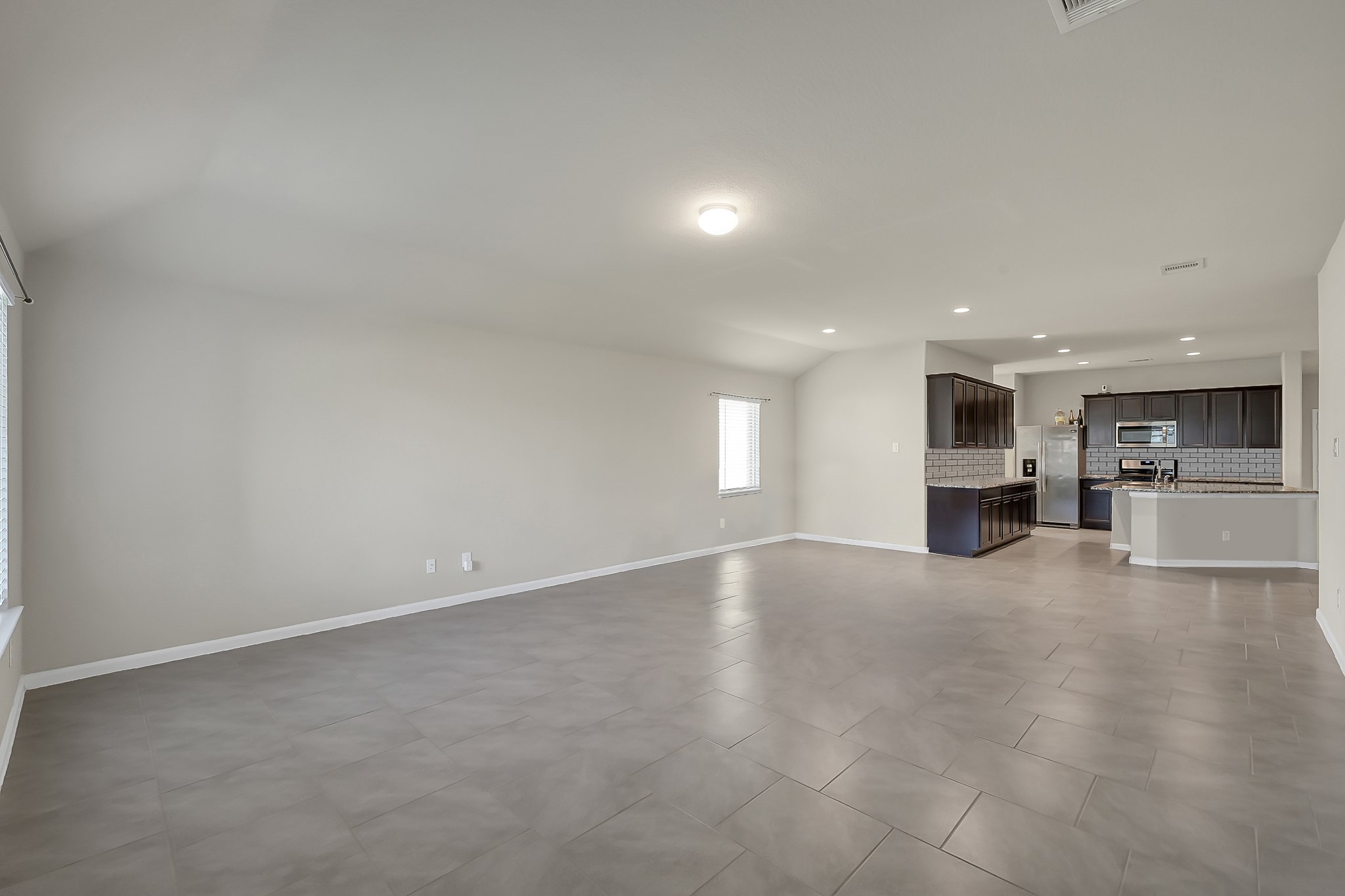 3310 Scout Island Katy, TX 77494 - Photo 13 of 42 a view of empty room with kitchen and window