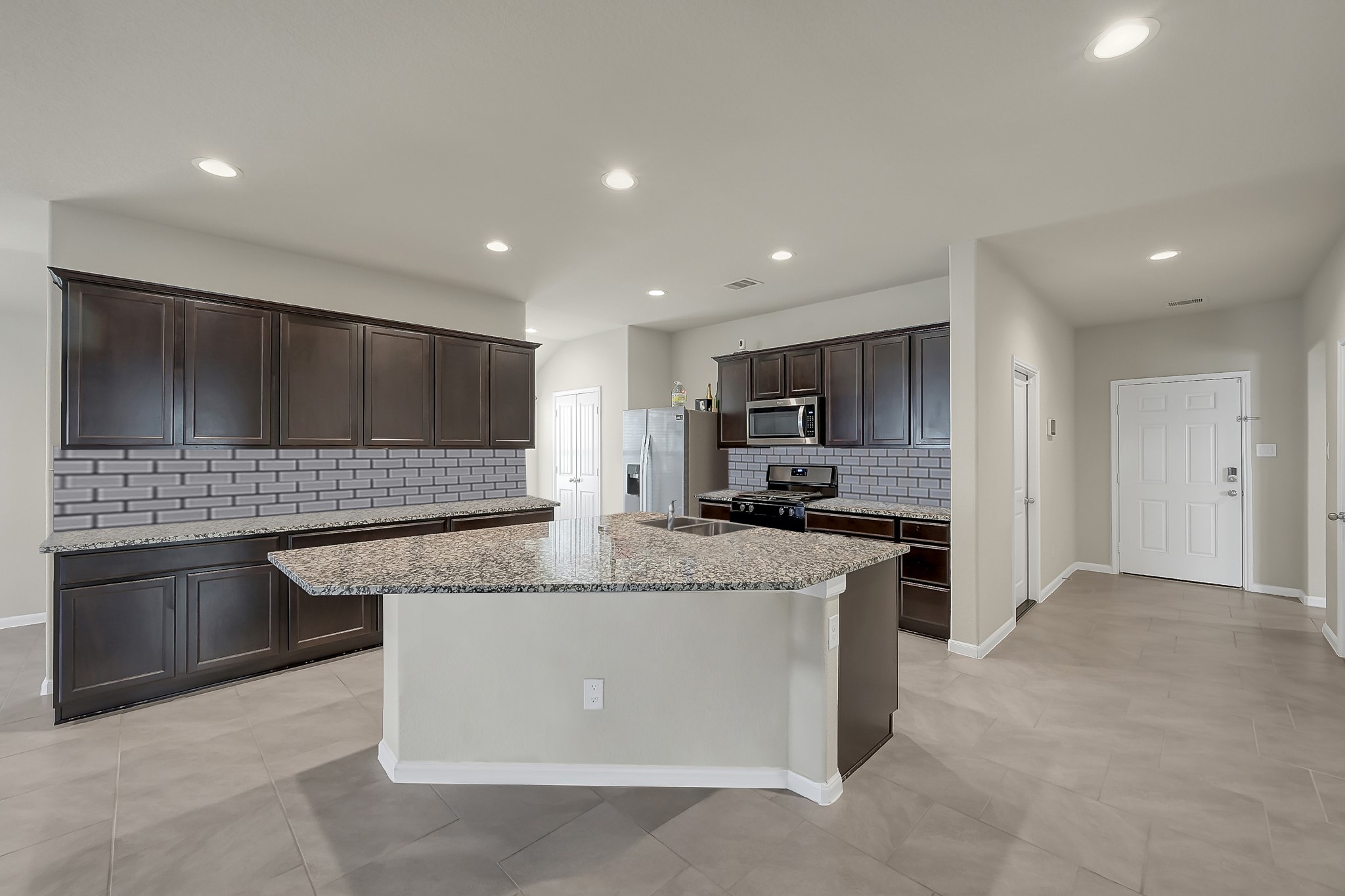 3310 Scout Island Katy, TX 77494 - Photo 6 of 42 a kitchen with stainless steel appliances granite countertop a sink and a stove top oven