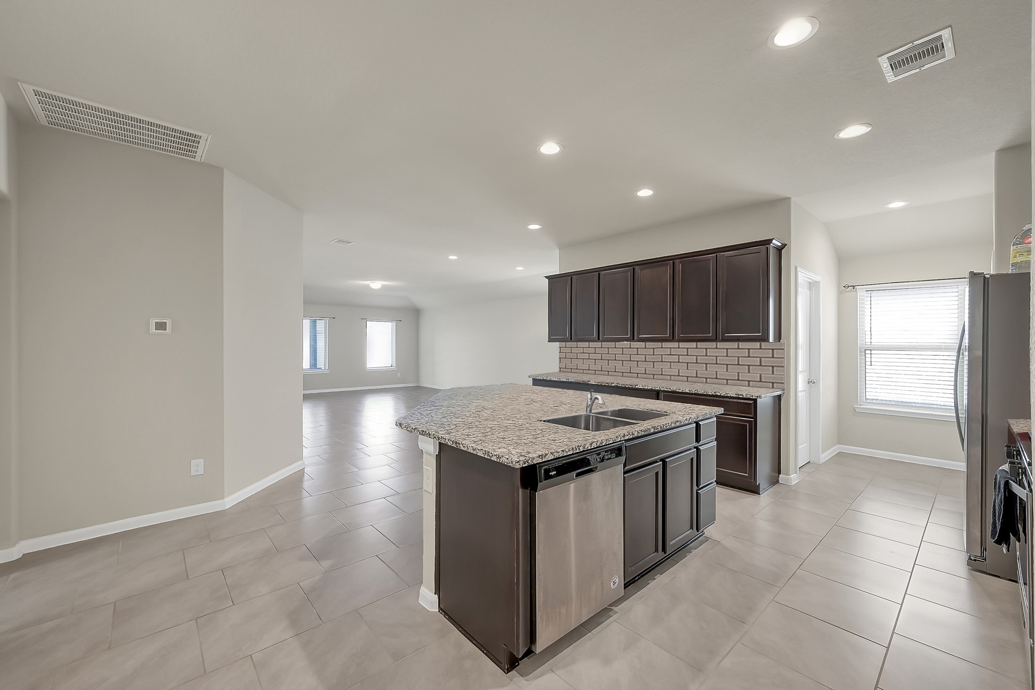 3310 Scout Island Katy, TX 77494 - Photo 10 of 42 a kitchen with a stove a refrigerator and a sink