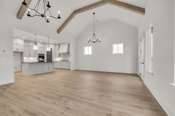 a view of an empty room with a fireplace and a window