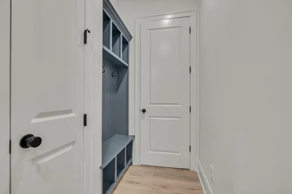 a view of a room with wooden floor and white cabinet